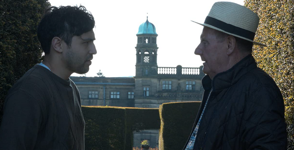 Main characters David and Lord Taverstone in front of the fictional Taverstone Hall