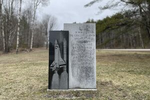 The Challenger Memorial. A block of South African granite serves as the surface for the illustration of The Challenger, while the other lists the names of the astronauts who perished in the explosion. 